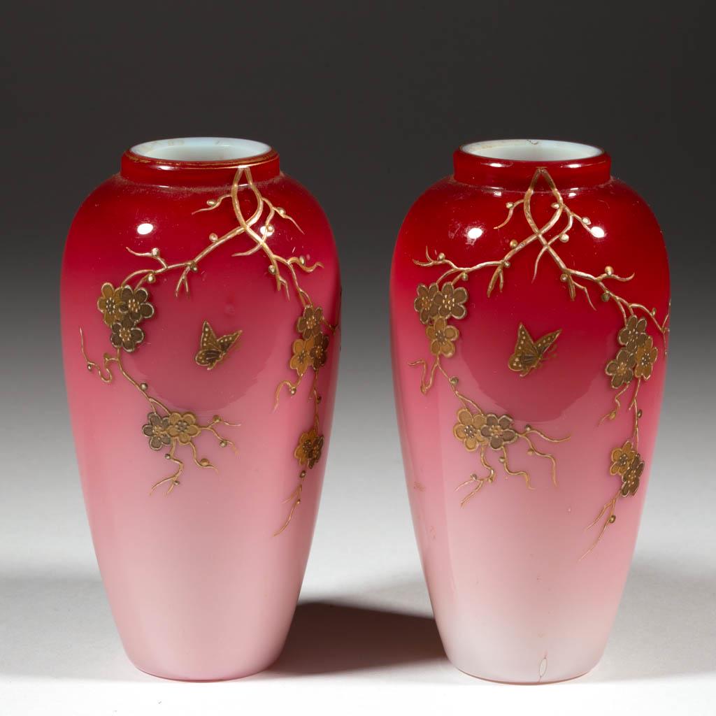 WEBB ENAMEL-DECORATED PEACHBLOW PAIR OF VASES: WEBB ENAMEL-DECORATED PEACHBLOW PAIR OF VASES, glossy with gilt enamel, each urn form with matching decoration depicting blooming branches and a butterfly. Thomas Webb & Sons. Fourth quarter 19th cent
