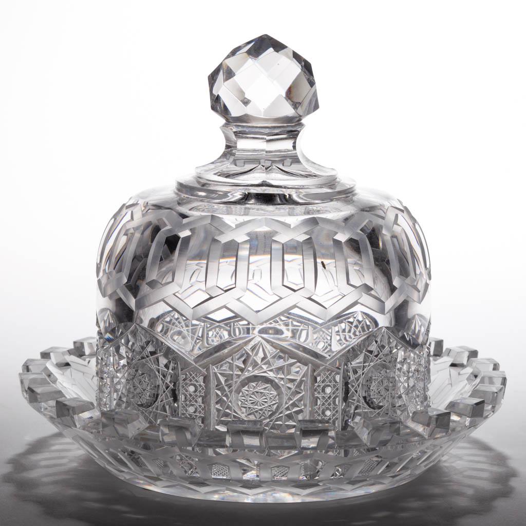 REPRODUCTION ALHAMBRA BRILLIANT CUT GLASS COVERED: REPRODUCTION ALHAMBRA BRILLIANT CUT GLASS COVERED BUTTER DISH, colorless lead glass, matching pattern underplate and cover, cut-faceted finial. Second half 20th century. 6 1/2" HOA, 7 1/2" D rim. Unda