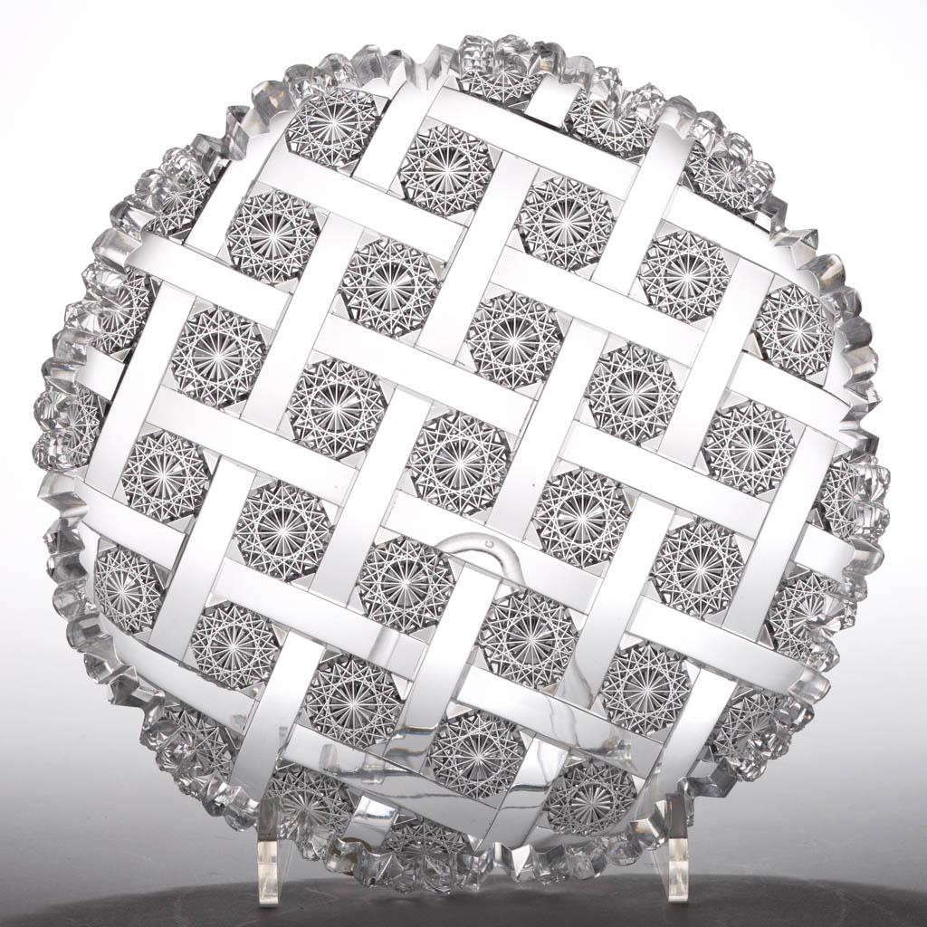 REPRODUCTION LATTICE AND ROSETTES BRILLIANT CUT GLASS: REPRODUCTION LATTICE AND ROSETTES BRILLIANT CUT GLASS PLATE, colorless lead glass, scalloped rim, faux acid-stamped signature. Second half 20th century. 8" D. Undamaged. Provenance: From the estate co