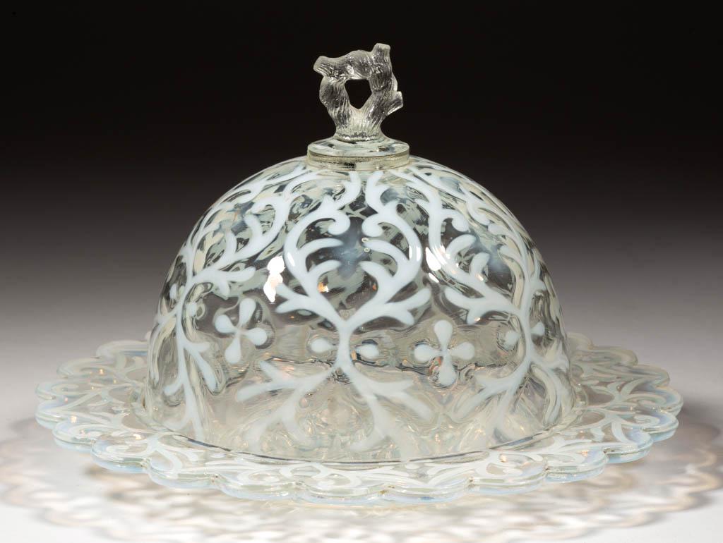 OPALINE BROCADE / SPANISH LACE COVERED BUTTER DISH: OPALINE BROCADE / SPANISH LACE COVERED BUTTER DISH, colorless opalescent, cover with factory-polished rim and branch finial. Northwood Glass Co. Pattern introduced 1899. 5 1/2" HOA, 8 1/4" DOA.Proof.