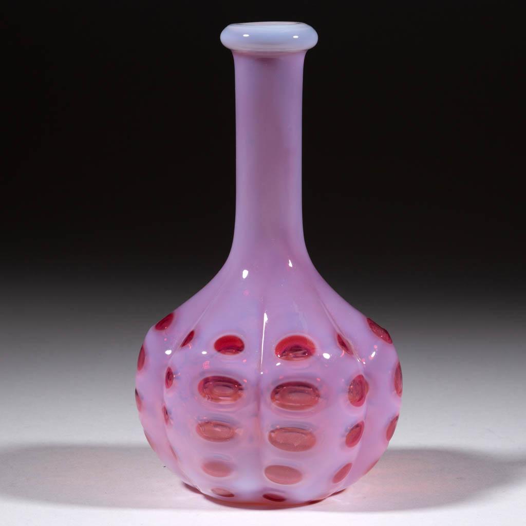 POLKA DOT BITTER'S / BARBER'S BOTTLE: POLKA DOT BITTER'S / BARBER'S BOTTLE, cranberry opalescent, six-lobe Melon Rib form. Probably West Virginia Glass Co. or Northwood Glass Co. Circa 1894. 6 7/8" H. Undamaged with interior residue. Lite