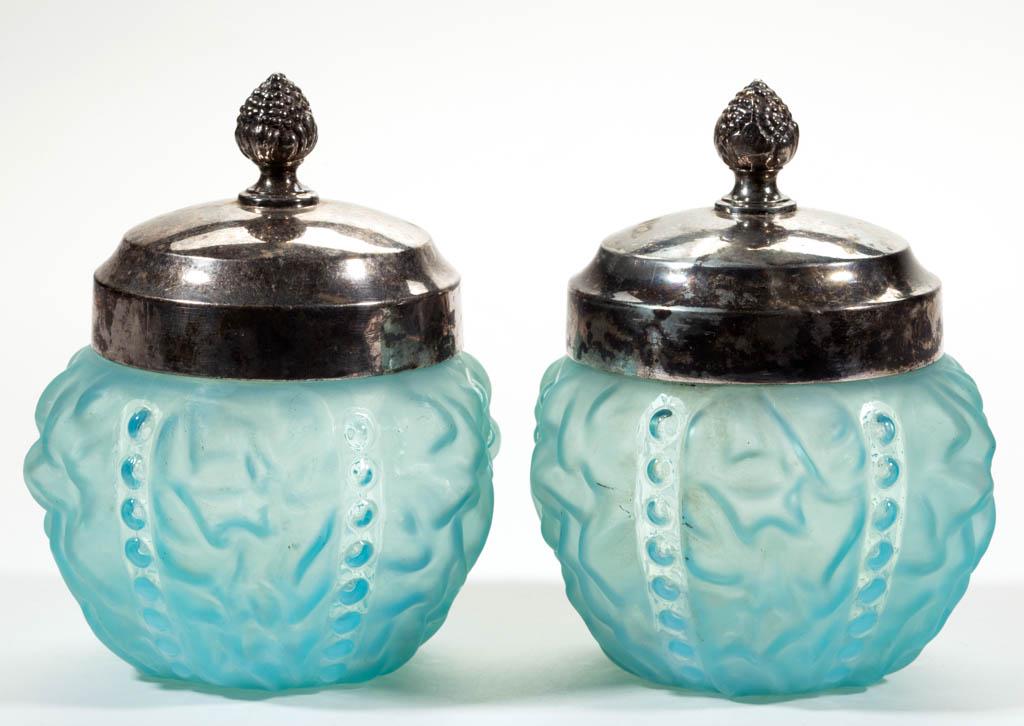 BEADED DRAPE COVERED JARS, LOT OF TWO: BEADED DRAPE COVERED JARS, LOT OF TWO, blue satin, period quadruple-plated covers. Pittsburgh Lamp, Brass & Glass Co. Circa 1900. 5 1/4" HOA, 3 1/4" H jars.Undamaged with scattered wear. Each having s