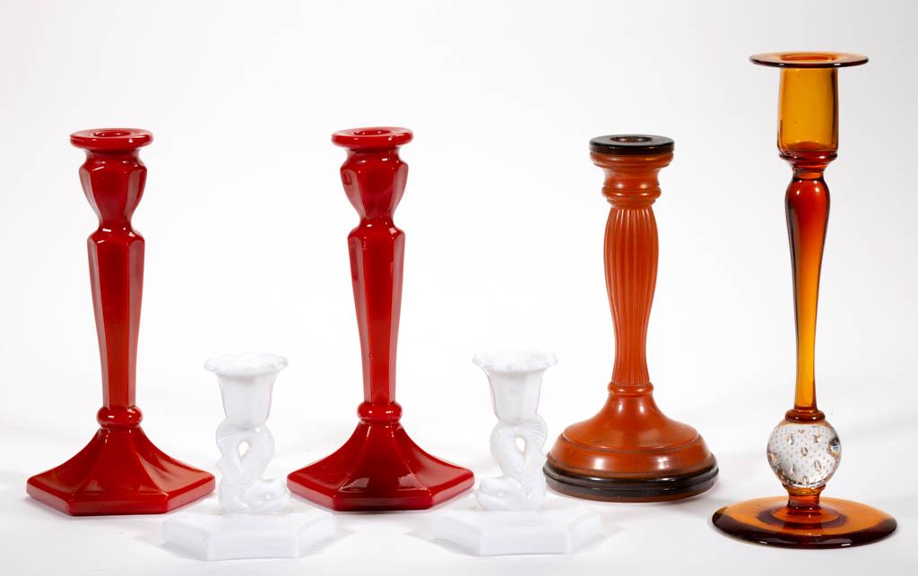 ASSORTED GLASS CANDLESTICKS, LOT OF SIX: ASSORTED GLASS CANDLESTICKS, LOT OF SIX, various makers, including a Fenton Mandarin Red hexagonal, an amber Pairpoint with controlled-bubble, a pair of opaque white dolphin-stem examples. Various mak