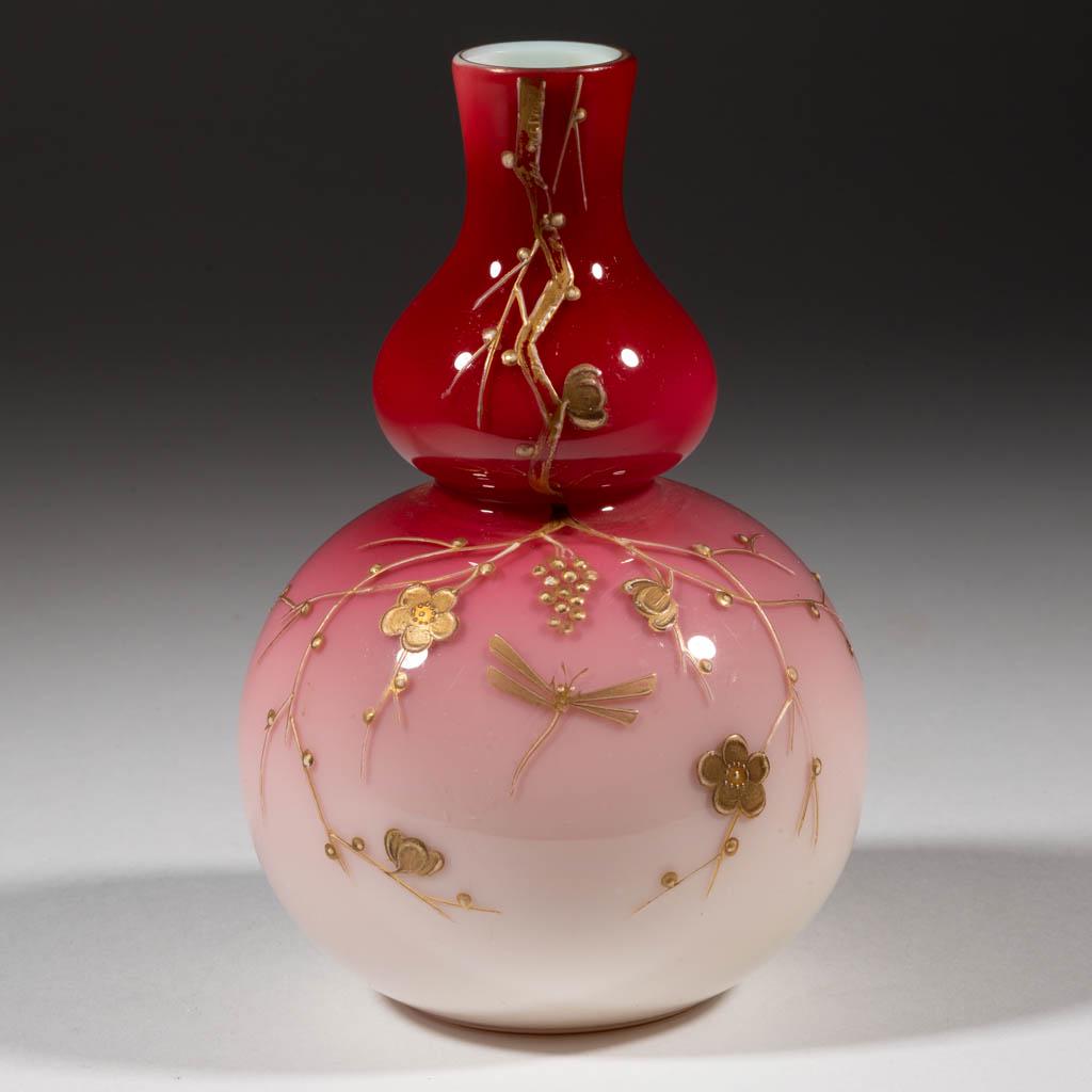 WEBB ENAMEL-DECORATED PEACHBLOW VASE: WEBB ENAMEL-DECORATED PEACHBLOW VASE, glossy with gilt enamel, gourd form, decoration depicting flowering branches and a dragonfly. Thomas Webb & Sons. Fourth quarter 19th century. 6" H. Undamaged wit
