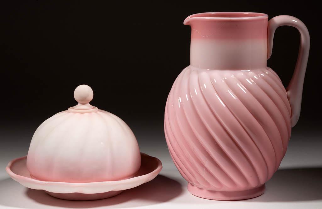ASSORTED PEACHBLOW GLASS ARTICLES, LOT OF TWO: ASSORTED PEACHBLOW GLASS ARTICLES, LOT OF TWO, comprising a glossy Reverse Swirled water pitcher, and a plush swirled butter dish. Various makers. Late 19th/first half 20th century. Pitcher: 8 5/8" H.