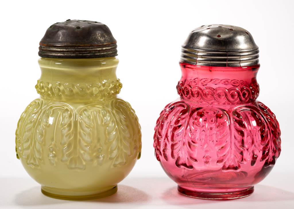 NORTHWOOD NO. 263 / LEAF UMBRELLA SUGAR SHAKERS, LOT OF: NORTHWOOD NO. 263 / LEAF UMBRELLA SUGAR SHAKERS, LOT OF TWO, Topaz / cased lemon glossy (reacts under black light) and cranberry, each having a period lid. Northwood Glass Co. Pattern introduced 1889.