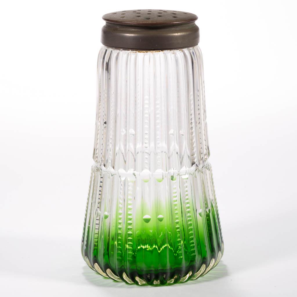 CUT ZIPPERED RIBS SUGAR SHAKER: CUT ZIPPERED RIBS SUGAR SHAKER, shaded green, medial break with alternating pairs of cut columns above and below, period two-part lid. Maker unverified, probably Moser. Fourth quarter 19th century. 5 