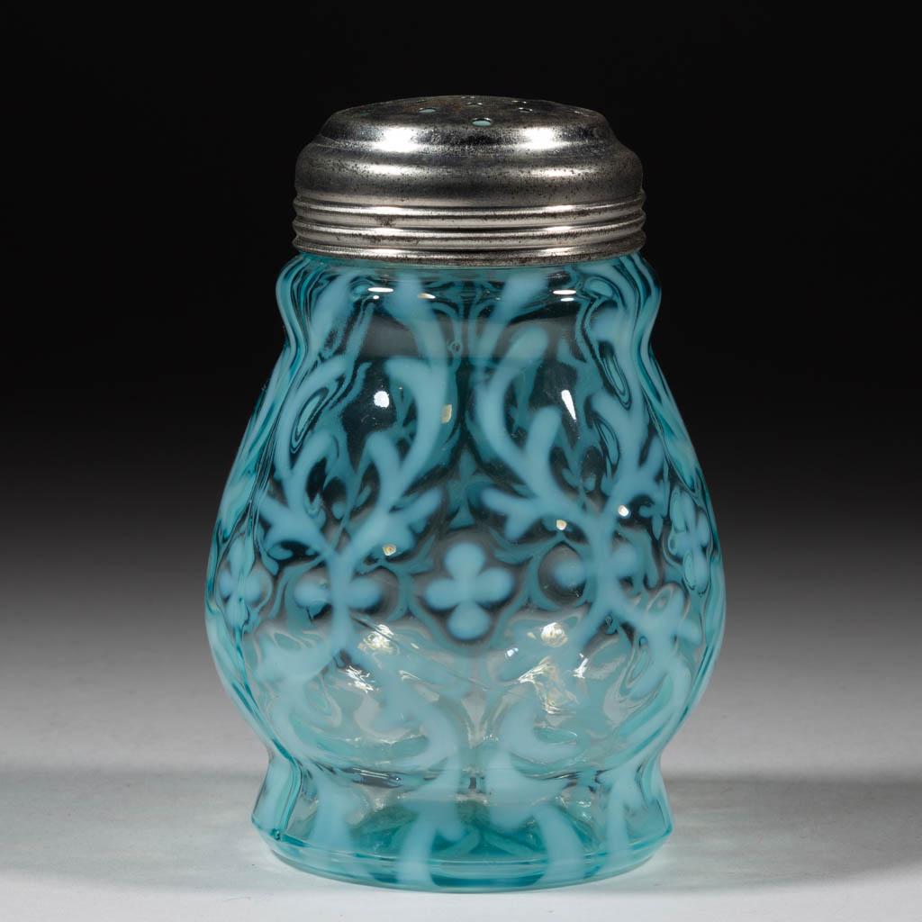 OPALINE BROCADE / SPANISH LACE SUGAR SHAKER: OPALINE BROCADE / SPANISH LACE SUGAR SHAKER, blue opalescent, period lid. Northwood Glass Co. Pattern introduced 1899. 4 1/2" H.Undamaged. Expected roughness to the mouth, as made.Literature: Parallel