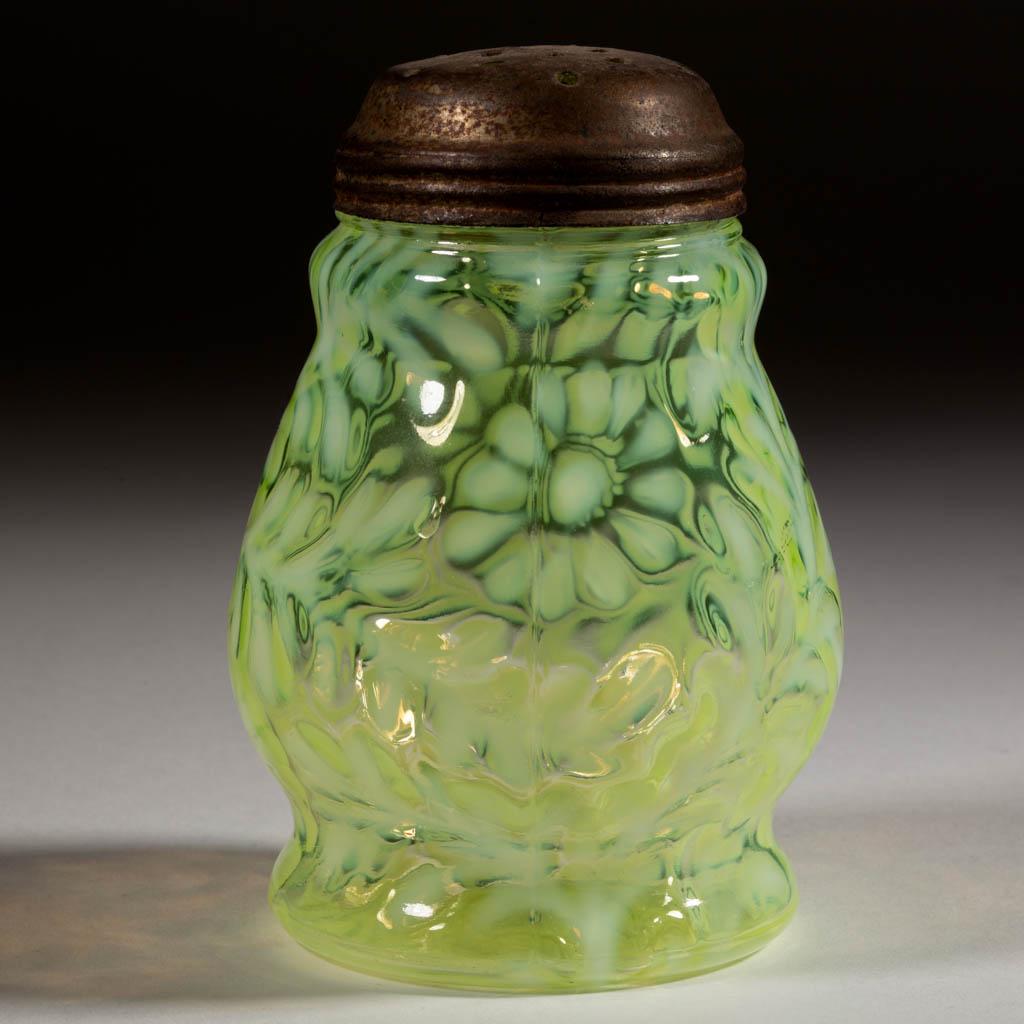 DAISY AND FERN - WIDE-WAISTED SUGAR SHAKER: DAISY AND FERN - WIDE-WAISTED SUGAR SHAKER, Vaseline (reacts under black light) opalescent, period lid. Various makers. 1888-1910. 4 3/4" H. Undamaged with the lid having overall rusting. Expected rou