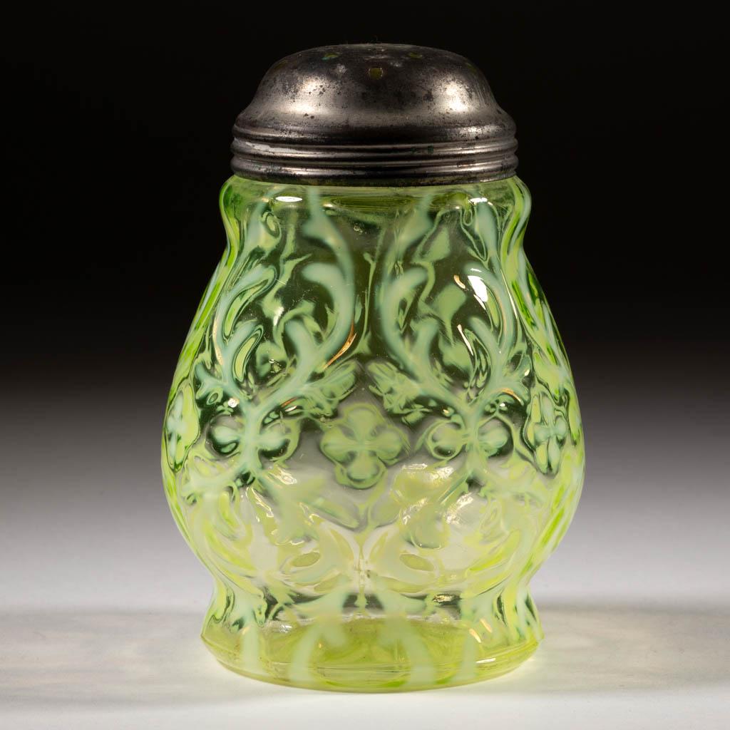 OPALINE BROCADE / SPANISH LACE SUGAR SHAKER: OPALINE BROCADE / SPANISH LACE SUGAR SHAKER, Vaseline (reacts under black light) opalescent, period lid. Northwood Glass Co. Pattern introduced 1899. 4 1/2" H.Undamaged. Expected roughness to the mout