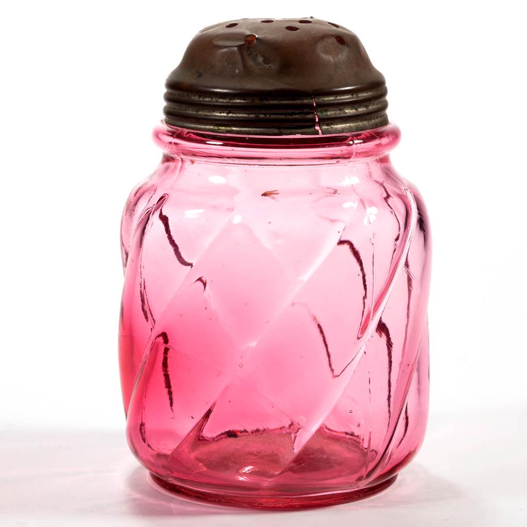 PARIAN SWIRL SUGAR SHAKER: PARIAN SWIRL SUGAR SHAKER, cranberry, period lid. The Northwood Glass Co. Circa 1894. 4 1/2" H. Excellent condition with a bruise to the mouth; lid having denting and some splitting. Expected roughnes