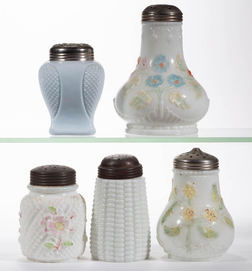 ASSORTED OPAQUE GLASS SUGAR SHAKERS, LOT OF FIVE: ASSORTED OPAQUE GLASS SUGAR SHAKERS, LOT OF FIVE, opaque white and opaque blue, including a Corn, an Apple Blossom, and two floral examples, each having a period lid. Various makers. Fourth quarter 19