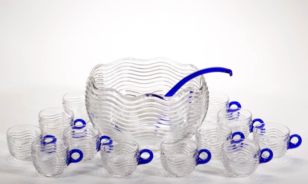 DUNCAN & MILLER CARIBBEAN PRESSED GLASS 14-PIECE PUNCH: DUNCAN & MILLER CARIBBEAN PRESSED GLASS 14-PIECE PUNCH SET, colorless and cobalt blue, comprising a punch bowl, ladle, and 12 punch cups. Duncan & Miller Glass Co. Circa 1936. Punch bowl: 6" H, 10" D 
