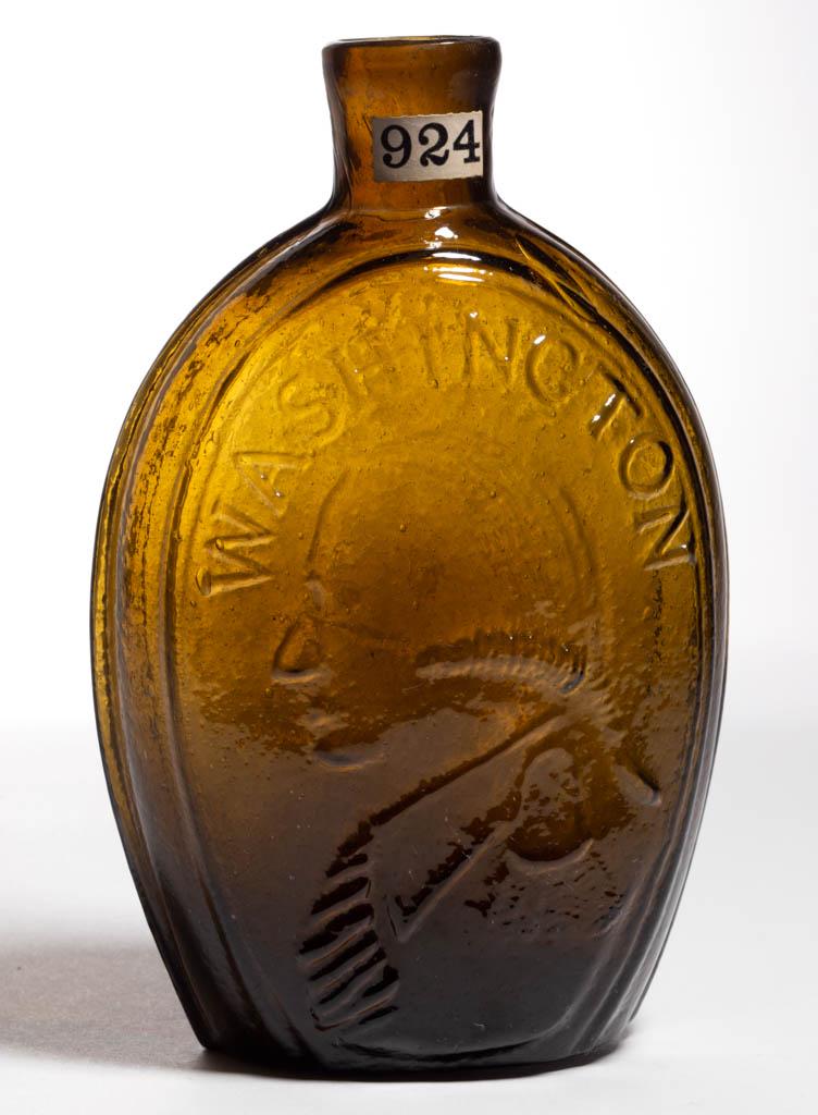 GI-31 WASHINGTON - JACKSON PORTRAIT / HISTORICAL FLASK: GI-31 WASHINGTON - JACKSON PORTRAIT / HISTORICAL FLASK, deep yellow olive, pint, obverse embossed "WASHINGTON", reverse embossed "JACKSON", plain mouth, rough pontil mark. Keene-Marlboro-Street Glassw