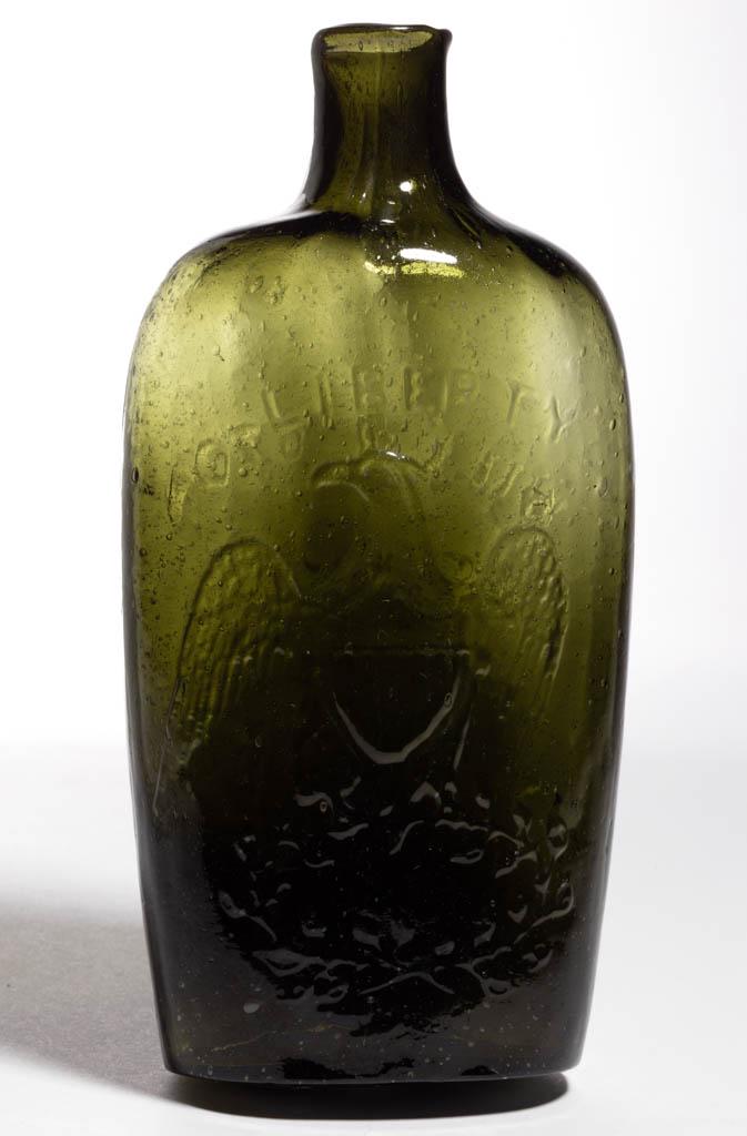 GII-62 EAGLE - WILLINGTON PICTORIAL / HISTORICAL FLASK: GII-62 EAGLE - WILLINGTON PICTORIAL / HISTORICAL FLASK, medium to deep olive green, pint, obverse embossed "LIBERTY" above eagle, reverse embossed, "WILLINGTON / GLASS, Co / WEST WILLINGTON / CONN", p