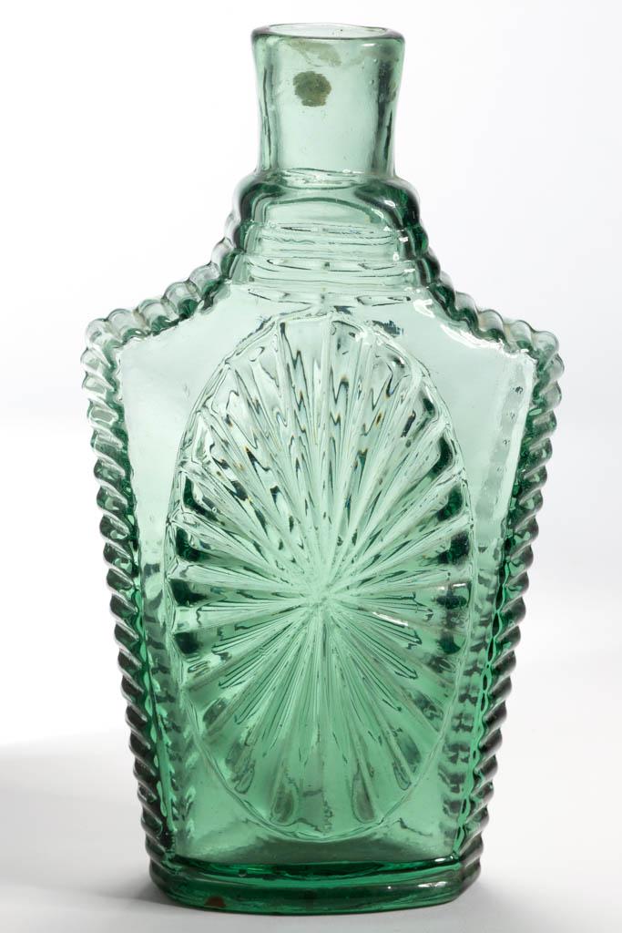 GVIII-2 SUNBURST FLASK: GVIII-2 SUNBURST FLASK, bright medium green, pint, plain mouth, rough pontil mark. New England. 1820-1840. 8" H.Undamaged with just a hint of wear.Literature: McKearin/Wilson - American Bottles & Flas