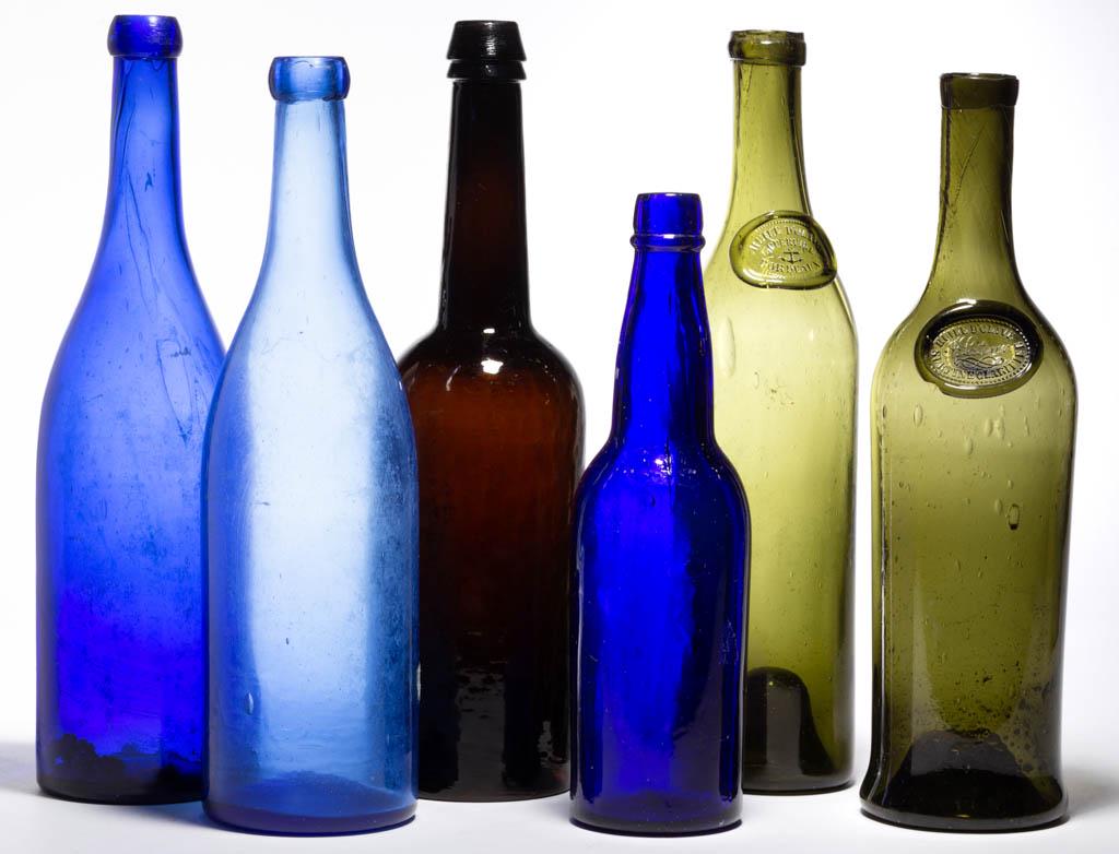 ASSORTED BOTTLES, LOT OF SIX: ASSORTED BOTTLES, LOT OF SIX, cobalt blue, olive green, and deep amber, each cylinder form, olive examples with applied seals for Huile D'Olive, applied and tooled mouths, amber example with iron pont