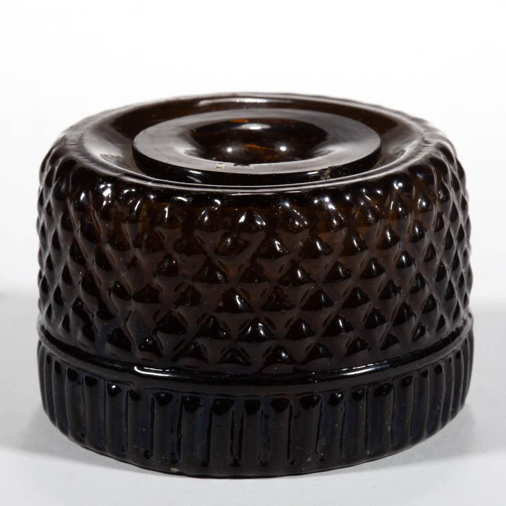 BLOWN-MOLDED GII-16 INKWELL: BLOWN-MOLDED GII-16 INKWELL, deep olive amber, applied mouth, plain base with rough pontil mark. Probably Coventry Glassworks (1815-1848), Coventry, Connecticut. 1815-1840. 1 1/2" H, 2 3/8" D. Undamag
