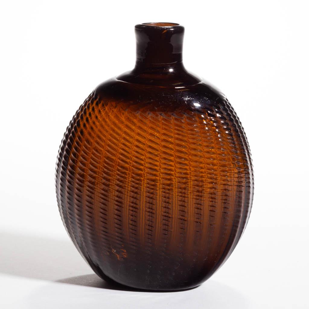 PATTERN-MOLDED HALF-POST PITKIN-TYPE FLASK: PATTERN-MOLDED HALF-POST PITKIN-TYPE FLASK, medium to dark brown amber, approximately one pint, flattened circular form, 36-rib broken-swirl, ribs swirled to the left, short neck with a plain mouth, k