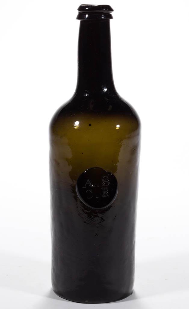 ENGLISH APPLIED SEAL BLACK GLASS WINE BOTTLE: ENGLISH APPLIED SEAL BLACK GLASS WINE BOTTLE, deep olive green, cylindrical form with medium neck, applied circular seal embossed "A.S / C.R" below shoulder, applied double-collar mouth, sand pontil m