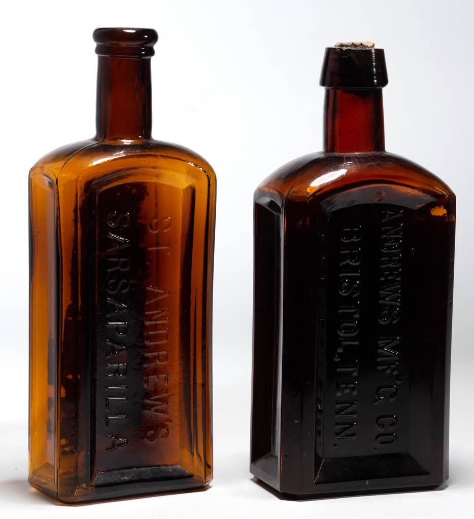 ANDREW'S SARSAPARILLA BOTTLES, LOT OF TWO: ANDREW'S SARSAPARILLA BOTTLES, LOT OF TWO, amber, each rectangular form, one embossed "ST. ANDREW'S / SARSAPARILLA" and with partial label lettered "FEMALE / REGULATOR" at top, second embossed "ANDREW