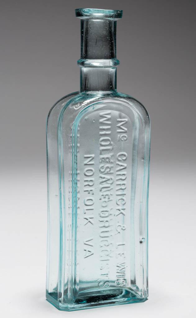 OLD HOMESTEAD, VIRGINIA SARSAPARILLA BOTTLE: OLD HOMESTEAD, VIRGINIA SARSAPARILLA BOTTLE, aquamarine, rectangular form embossed on two sides, "OLD HOMESTEAD / SARSAPARILLA - Mc CARRICK & LEWIS / WHOLESALE DRUGGISTS / NORFOLK, VA.", ringed neck, 