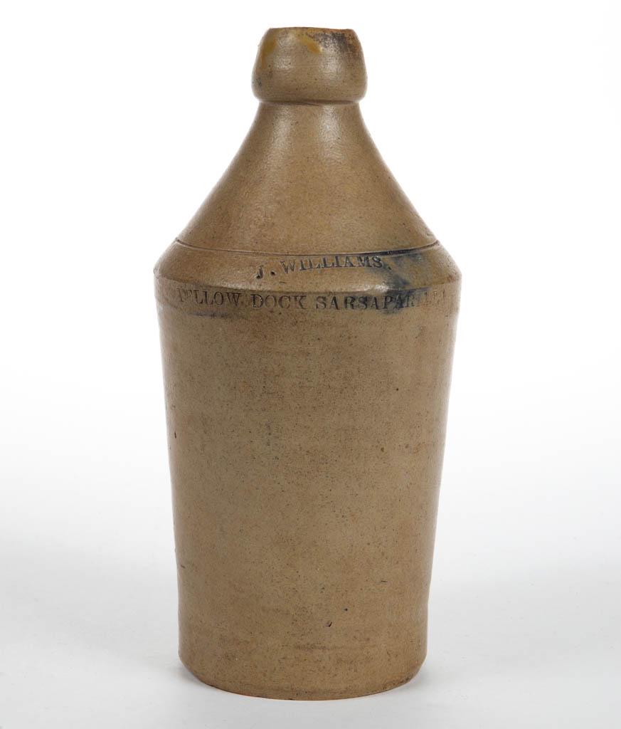 WILLIAMS STONEWARE SARSAPARILLA BOTTLE: WILLIAMS STONEWARE SARSAPARILLA BOTTLE, salt-glazed, slightly tapered form with sharp shoulder, stamped "J. WILLIAMS. / YELLOW DOCK SARSAPARILLA" on shoulder, brushed cobalt highlighting stamp, blob m