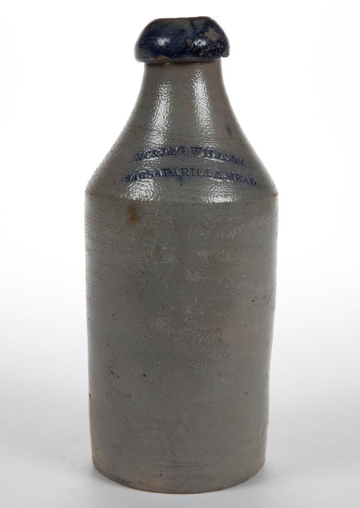 WILLSON STONEWARE SARSAPARILLA BOTTLE: WILLSON STONEWARE SARSAPARILLA BOTTLE, salt-glazed, cylindrical form with sharp shoulder, stamped "WC&J&G. WILLSON / SARSAPARILLA MEAD" on shoulder, brushed cobalt highlighting stamp and broad rounded