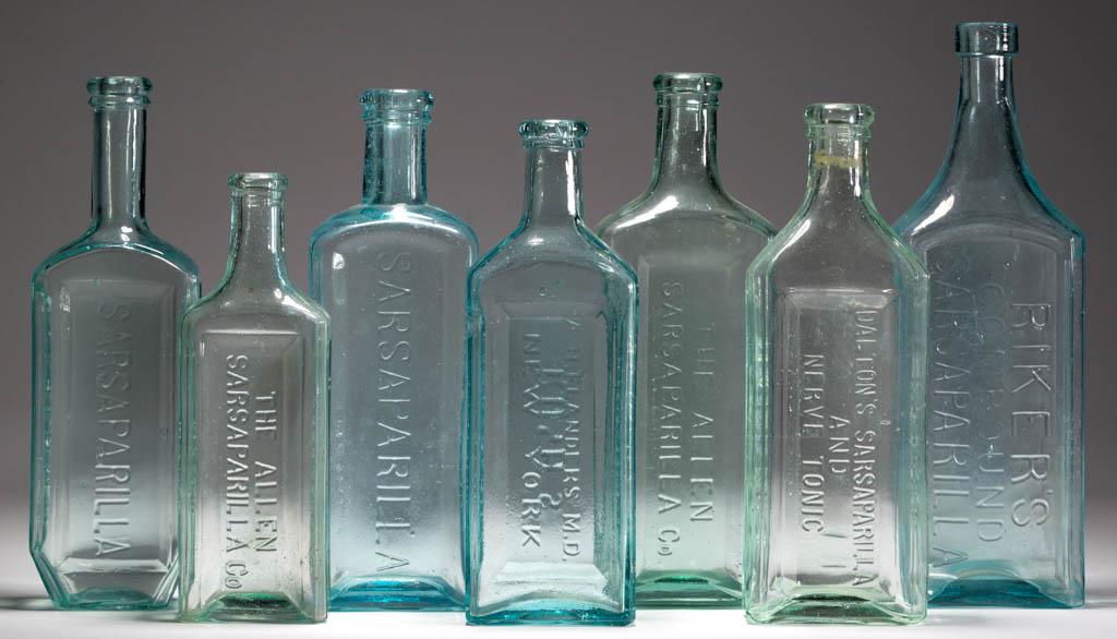 ASSORTED SARSAPARILLA BOTTLES, LOT OF SEVEN: ASSORTED SARSAPARILLA BOTTLES, LOT OF SEVEN, aquamarine and light green, each rectangular form, embossed for McLean's, Dalton's, Riker's Compound, Rush's/A. H, Flanders M.D., Wetherell's (coffin shape