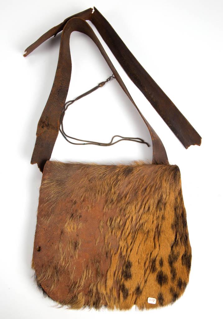 FRONTIERSMAN'S BUCKSKIN HUNTING ACCOUTREMENT BAG: FRONTIERSMAN'S BUCKSKIN HUNTING ACCOUTREMENT BAG, with leather strap. 19th century. 10 1/4" x 9" OA. Fair overall condition, heavy areas of loss to fur, and old breaks to leather strap. Provenance: Fr