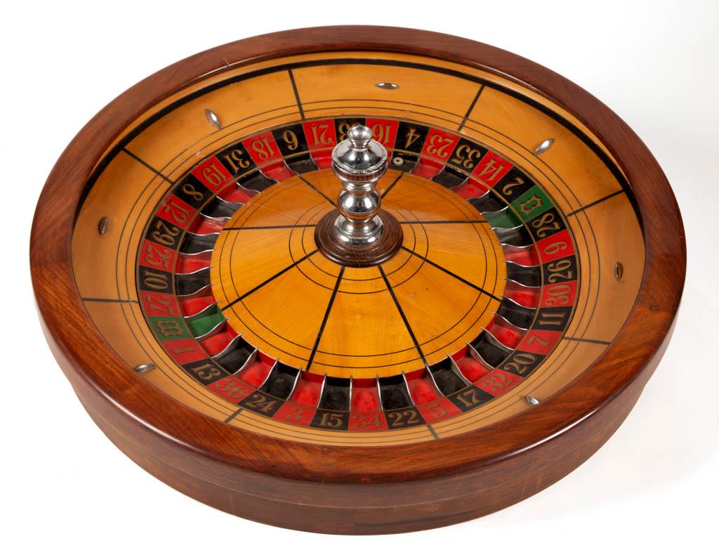 ANTIQUE ROULETTE / GAMBLING TABLE: ANTIQUE ROULETTE / GAMBLING TABLE, mahogany, maple, ebony, and chrome wheel with original hand-painted and stenciled ball track, marked "H. C. EVANS / CHICAGO", set on a rectangular table raised on tr