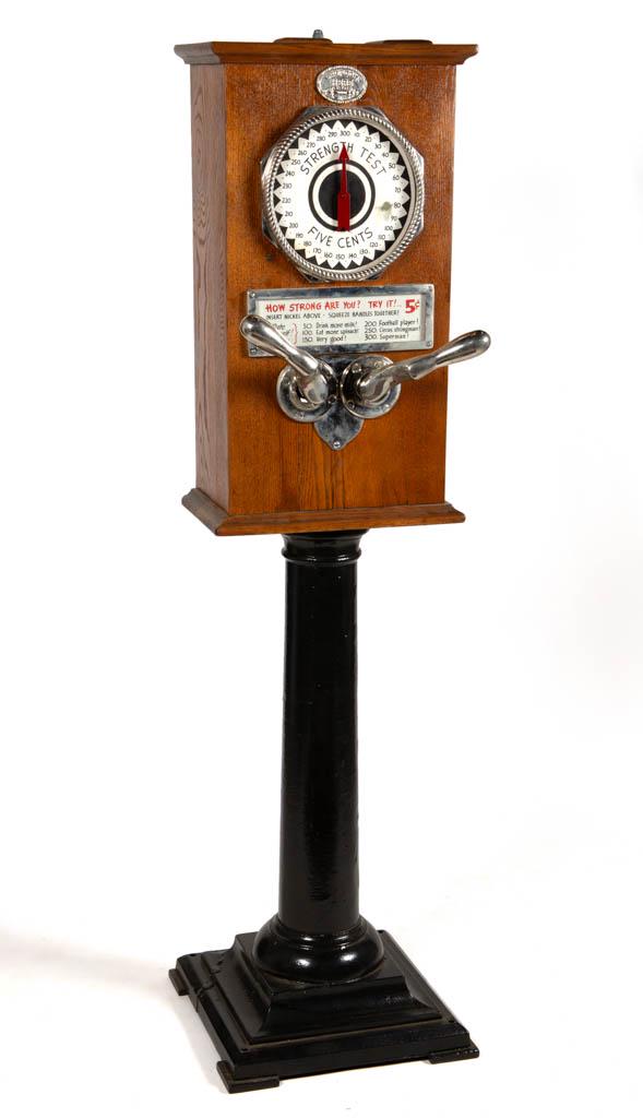 VINTAGE FLOOR-MODEL FIVE-CENT STRENGTH TESTER ARCADE: VINTAGE FLOOR-MODEL FIVE-CENT STRENGTH TESTER ARCADE GAME, oak case on a black-painted cast-iron base, chrome handles. Circa 1930. 64" H, 17" SQ base. Good overall visual condition, cast-iron base wit