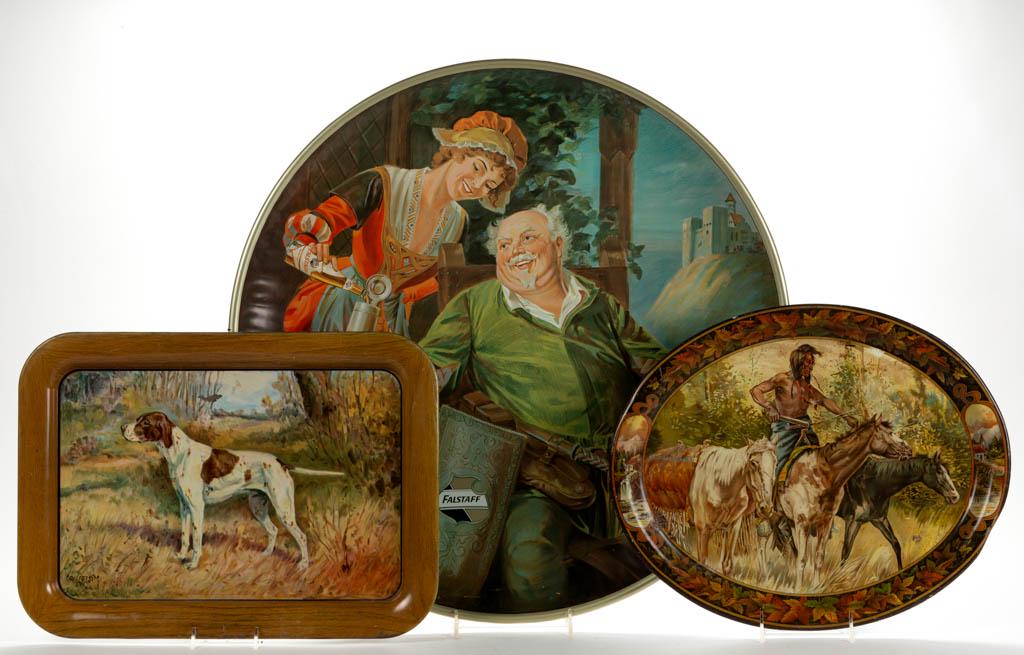 ANTIQUE TIN ADVERTISING TRAYS, LOT OF TWO: ANTIQUE TIN ADVERTISING TRAYS, LOT OF TWO, one example depicting a hunting dog in landscape, and the other an American Indian on horseback. Together with a reproduction Falstaff Brewing tin tray plaqu