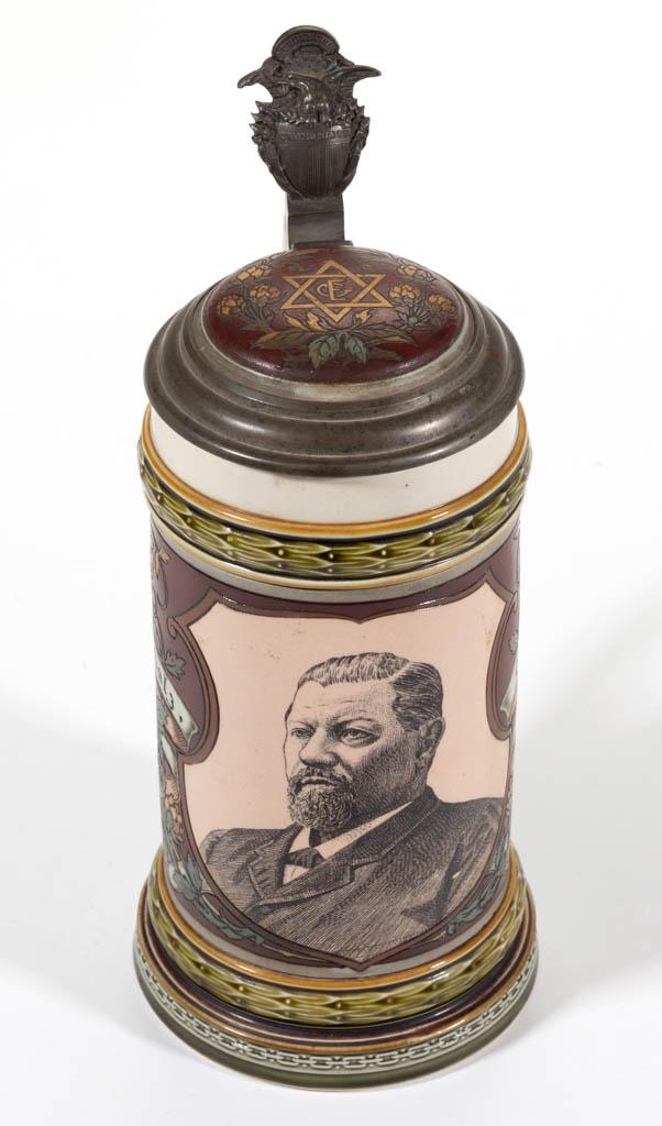 GERMAN METTLACH GEORGE EHRET BREWER CERAMIC STEIN: GERMAN METTLACH GEORGE EHRET BREWER CERAMIC STEIN, mold number 1997, having etched sides with transfer-printed portrait vignette, ceramic inset metal lid with United States shield and eagle thumbrest.