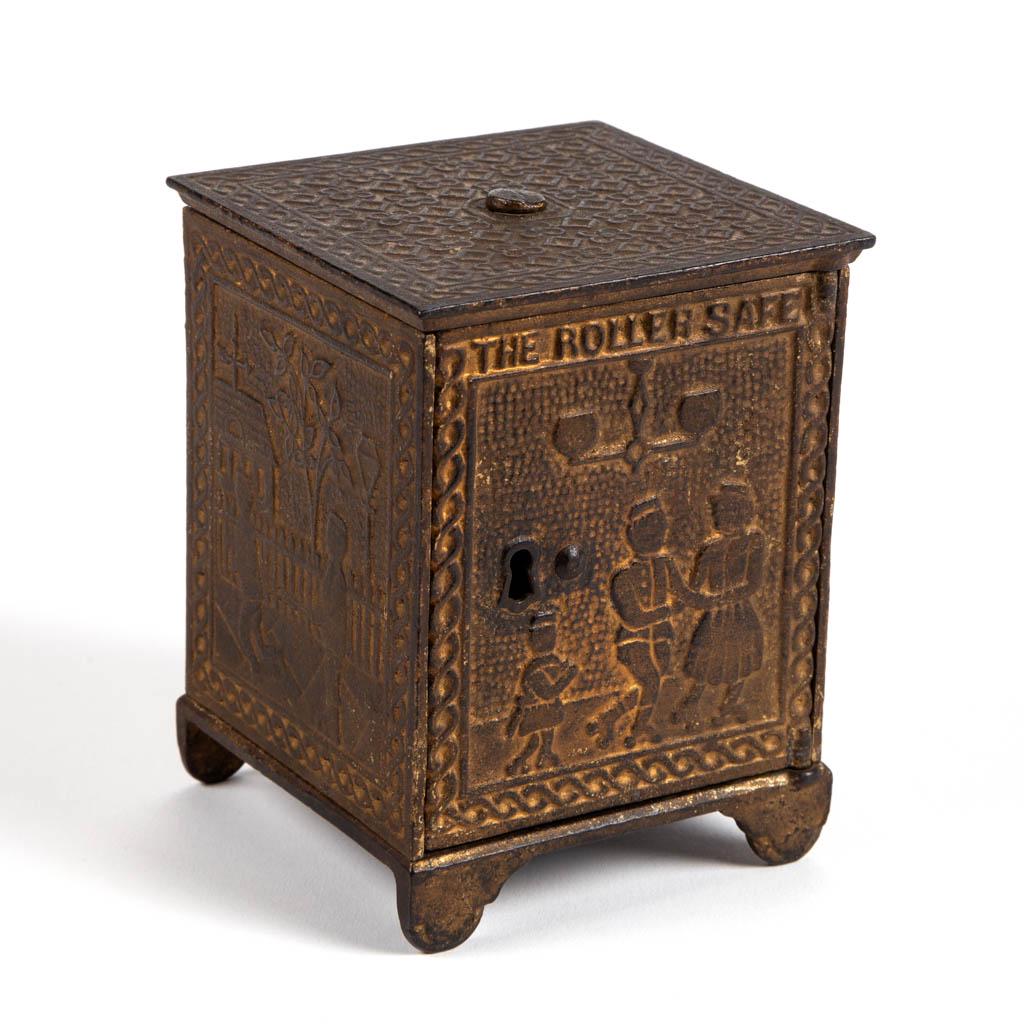THE ROLLER SAFE CAST-IRON STILL / PENNY BANK: THE ROLLER SAFE CAST-IRON STILL / PENNY BANK, marked "PAT. JAN'Y. 8. 82" to underside of base, original paint. Circa 1882. 3 3/4" H. Very good overall condition with minor surface wear, heavier to top