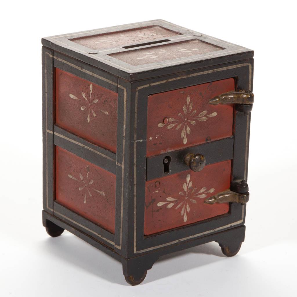STEVENS CAST-IRON STENCILED-DOOR SAFE PENNY/ STILL BANK: STEVENS CAST-IRON STENCILED-DOOR SAFE PENNY/ STILL BANK, with center knob. Original paint. J & E Stevens Co., Cromwell, CT. Fourth quarter 19th century. 4 1/4" H. Very good overall condition with very