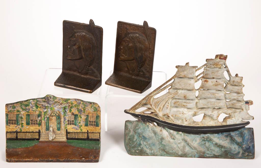 ASSORTED CAST-IRON FIGURAL DOORSTOPS, LOT OF TWO: ASSORTED CAST-IRON FIGURAL DOORSTOPS, LOT OF TWO, comprising a woman entering a house example, embossed on the reverse "EASTERN.SPECIALTY.MFG.CO. / NO. 50", and a clipper ship example, with a "3" stam