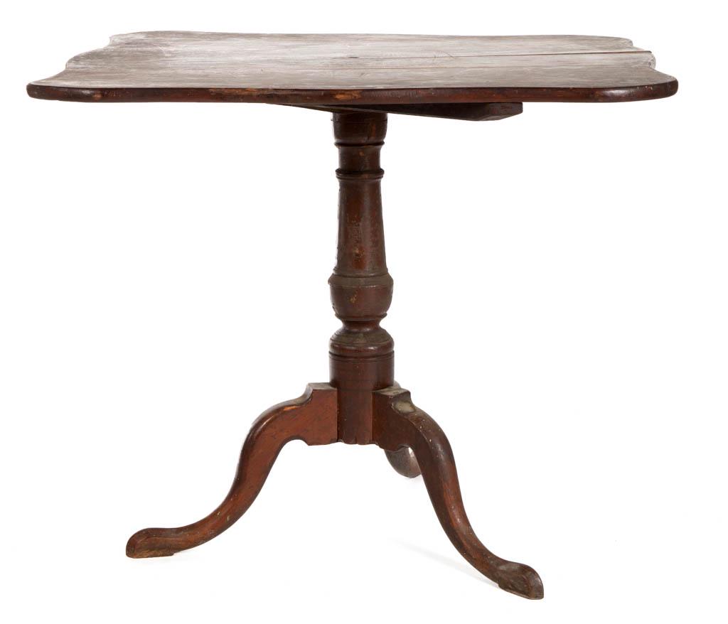 NEW ENGLAND QUEEN ANNE CHERRY TEA TABLE: NEW ENGLAND QUEEN ANNE CHERRY TEA TABLE, shaped three-board top over an urn-turned pedestal, raised on tripodal base with cabriole legs ending in peaked and padded feet. Early surface with rich color.