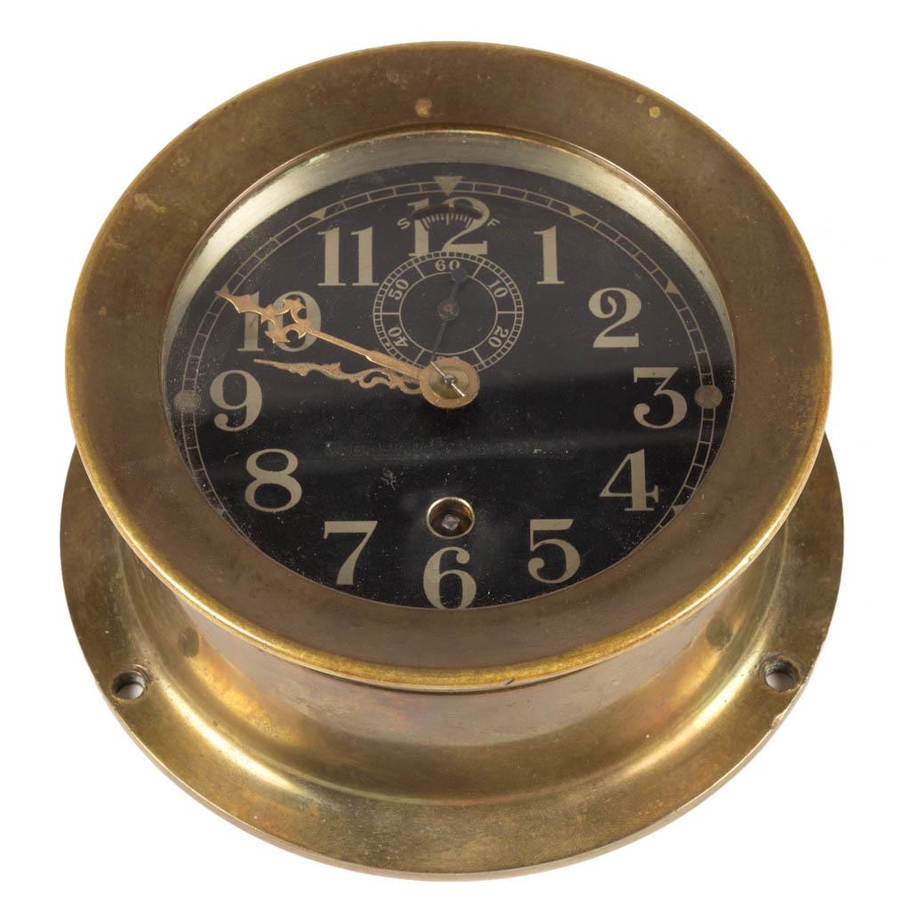 SETH THOMAS BRASS NAUTICAL SHIP'S CLOCK: SETH THOMAS BRASS NAUTICAL SHIP'S CLOCK, with dial marked "MADE BY SETH THOMAS in U.S.A.", back is stamped "G21", with three holes for mounting. 20th century. 2 1/2" H, 5 1/4" D.Very good overall cond