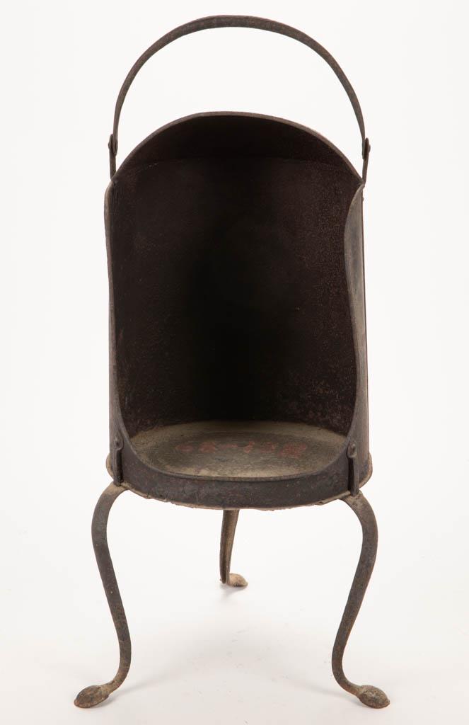 SHEET-IRON AND WROUGHT-IRON HEARTH UPRIGHT WARMING: SHEET-IRON AND WROUGHT-IRON HEARTH UPRIGHT WARMING PLATE OVEN, circular form with hood and open front, raised on three curved legs with penny feet, top supported by a bail handle. 19th century. 25 1/2