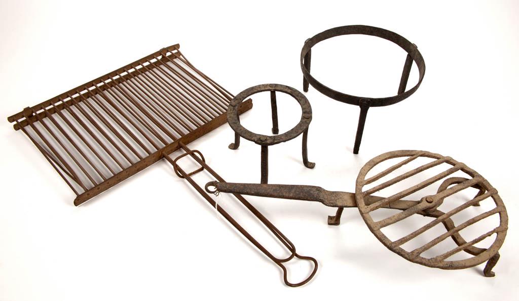 ASSORTED WROUGHT-IRON HEARTH COOKING ARTICLES, LOT OF: ASSORTED WROUGHT-IRON HEARTH COOKING ARTICLES, LOT OF FOUR, comprising two circular-form trivets with each raised on three simple legs, a rotating broiler/grill raised on three legs, and a rectangular