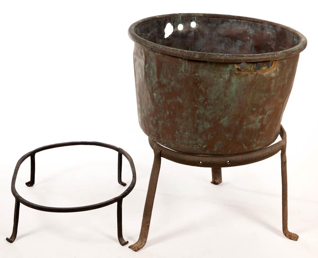 ASSORTED COPPER AND WROUGHT-IRON DOMESTIC ARTICLES, LOT: ASSORTED COPPER AND WROUGHT-IRON DOMESTIC ARTICLES, LOT OF THREE, comprising an apple butter kettle with dovetailed construction, a circular-form wrought-iron kettle ring/trivet, and an oval-form triv