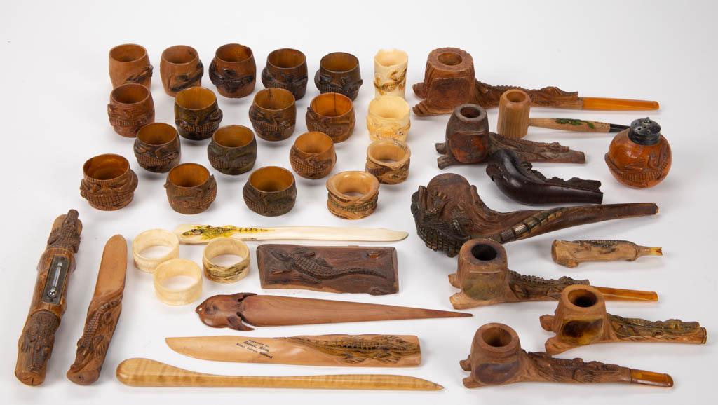 ASSORTED AMERICAN FOLK ART CARVED TOURIST ARTICLES, LOT: ASSORTED AMERICAN FOLK ART CARVED TOURIST ARTICLES, LOT OF 39, including pipes and napkin ring holders depicting alligators. First half 20th century. Largest pipe 8 1/2" L.Good to excellent overall co