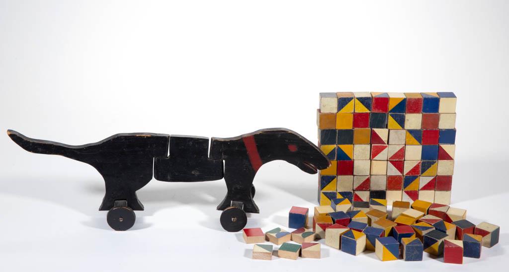 AMERICAN FOLK ART PAINTED WOODEN FIGURAL PULL TOY: AMERICAN FOLK ART PAINTED WOODEN FIGURAL PULL TOY, possibly a dachshund. Retains probably original red- and black-painted surface. Together with approximately 80 painted wooden blocks. First half 20th