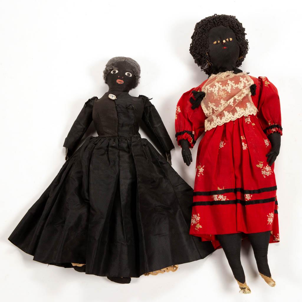 BLACK AMERICANA CLOTH DOLLS, LOT OF TWO: BLACK AMERICANA CLOTH DOLLS, LOT OF TWO, depicting adult ladies in formal dress attire, comprising an example in a red dress with white floral print and lace front, hand-stitched facial features, and 