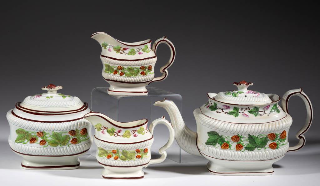 ENGLISH STRAWBERRY VINE-DECORATED CERAMIC PARTIAL TEA: ENGLISH STRAWBERRY VINE-DECORATED CERAMIC PARTIAL TEA SET, LOT OF FOUR, comprising a teapot, a covered sugar, and two creamers, each having central relief polychrome hand-painted strawberry and leaf d