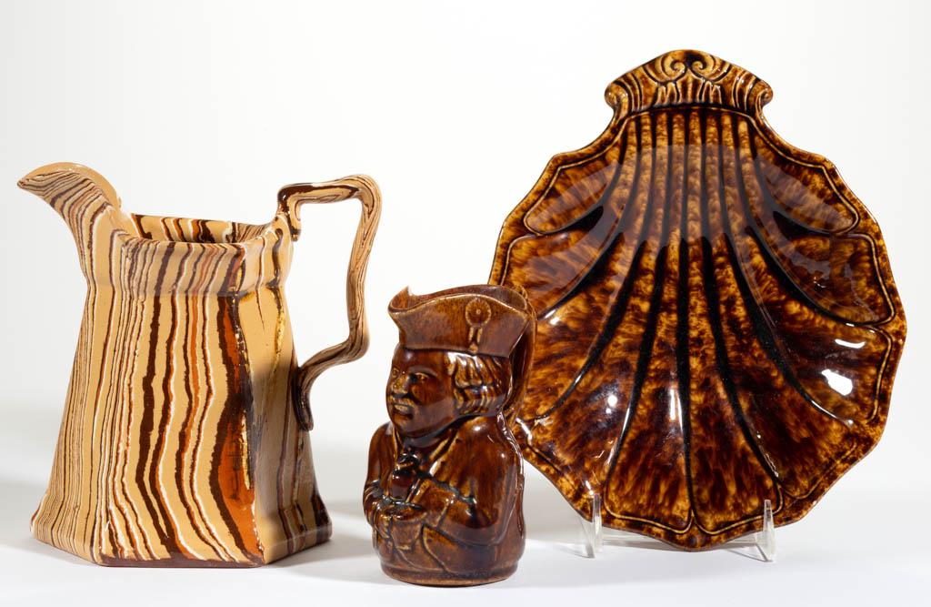 AMERICAN ROCKINGHAM-GLAZE POTTERY ARTICLES, LOT OF TWO: AMERICAN ROCKINGHAM-GLAZE POTTERY ARTICLES, LOT OF TWO, mottled brown, comprising a Toby pitcher and a 10 7/8" x 9 1/2" molded shell dish. Together with a 8" H agate/scroddle ware pitcher having hexag