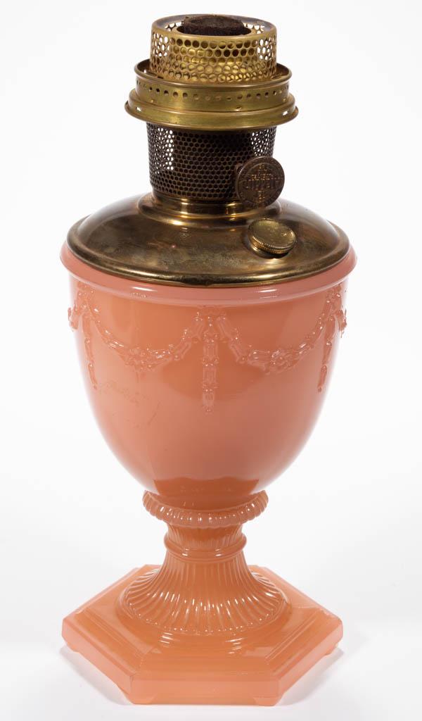 ALADDIN MODEL NO. 103 / FLORENTINE KEROSENE VASE LAMP: ALADDIN MODEL NO. 103 / FLORENTINE KEROSENE VASE LAMP, Rose Moonstone, urn-form vase with drapery around the bowl having original interior paint, ribbed and waisted standard, hexagonal foot. Fitted wi