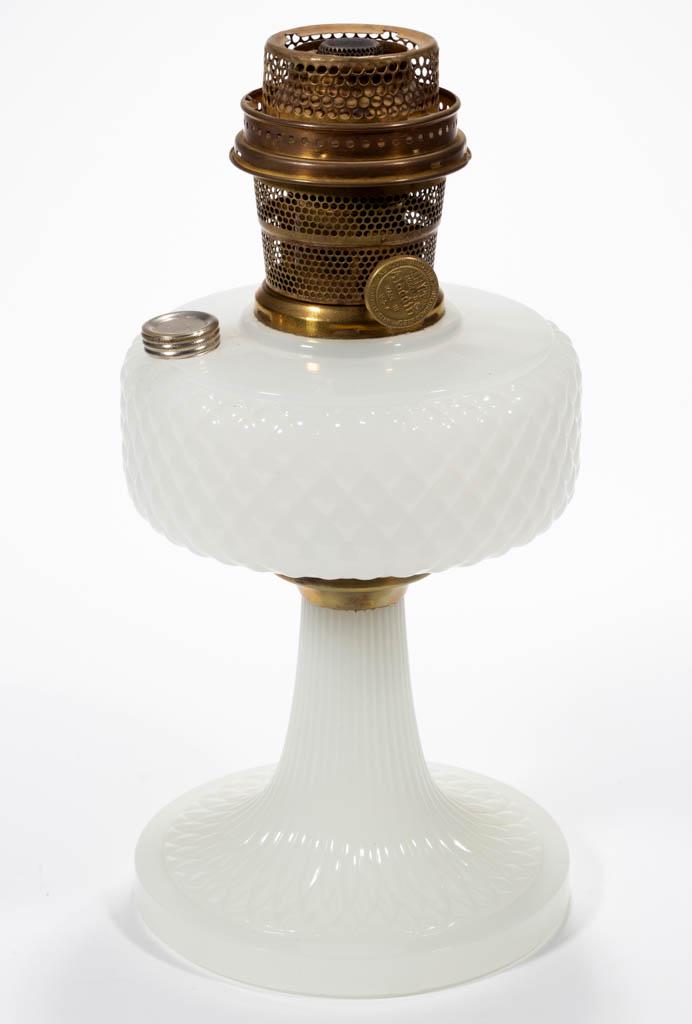 ALADDIN MODEL B-85 / DIAMOND-QUILT KEROSENE STAND LAMP: ALADDIN MODEL B-85 / DIAMOND-QUILT KEROSENE STAND LAMP, White Moonstone font and base, brass connector, brass crimped collar. Fitted with a brass Model-B "NASHVILLE" burner having flame spreader. The