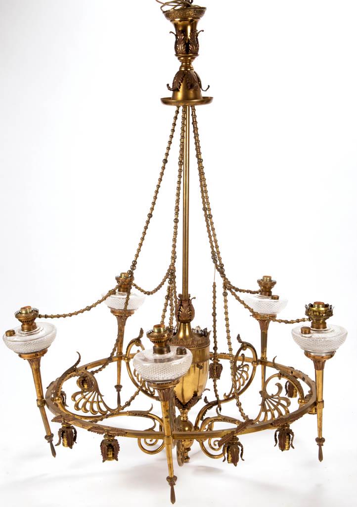 VICTORIAN MIXED-METAL KEROSENE AND ELECTRIC CHANDELIER: VICTORIAN MIXED-METAL KEROSENE AND ELECTRIC CHANDELIER, central pole with a large bullet-form centerpiece and a lower ovoid central hub supporting five scrolling and foliate arms, out band supporting 